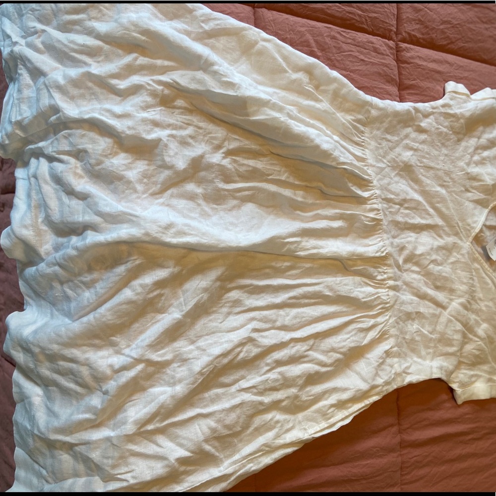 White linen dress with pockets.
